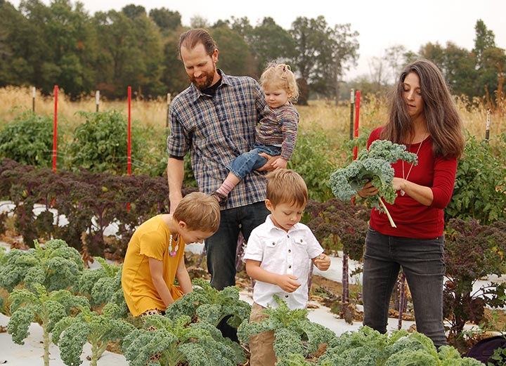 Photo of Barr Family picking veggies on the farm at Barr Farms